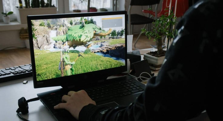 Teenager playing Palworld game released earlier this year on a Windows laptop at home