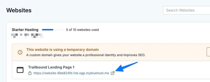 In the Websites page on Bluehost, blue arrow pointing to the domain URL