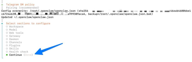 OpenClaw configure terminal showing a successful config overwrite of the openclaw.json file with a SHA256 hash confirmation, and a blue arrow pointing to the Continue (Done) option at the bottom of the Select sections to configure menu