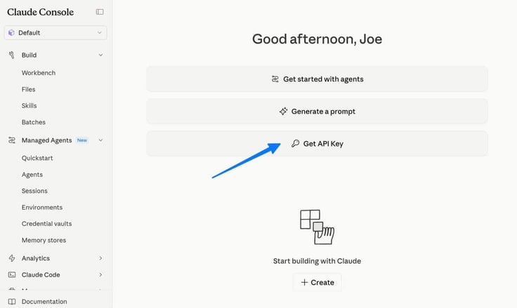 Anthropic Claude Console dashboard showing a personalized greeting and three quick-action buttons including Get started with agents, Generate a prompt, and Get API Key, with a blue arrow pointing to the Get API Key button, and the left navigation showing Build, Managed Agents, and Analytics sections
