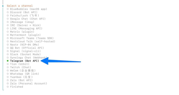 OpenClaw configure terminal showing the full Select a channel list with over 20 messaging platform options including Discord, iMessage, Signal, Slack, WhatsApp, and others, with a blue arrow pointing to Telegram (Bot API) selected with a green dot OpenClaw configure terminal showing the full Select a channel list with over 20 messaging platform options including Discord, iMessage, Signal, Slack, WhatsApp, and others, with a blue arrow pointing to Telegram (Bot API) selected with a green dot