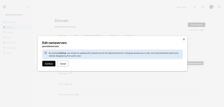 GoDaddy Edit Nameservers confirmation modal dialog for journalancer.com showing a blue warning banner stating that changing nameservers is risky and could cause the website to disappear from public view, with Continue and Cancel buttons