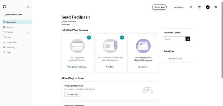 GoDaddy account dashboard for Sead Fadilpasic showing journalancer.com with the Let's Build Your Business section displaying three completed steps â domain registered, website connected, and a pending Get Custom Email prompt â alongside a Find a New Domain search widget and Quick Links with a Manage Domain option