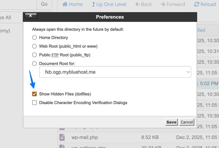 A file manager Preferences dialog box displays radio button options for default directory settings including Home Directory, Web Root, Public FTP Root, and Document Root for "fxb.ogp.mybluehost.me" shown in a dropdown with a blue arrow pointing toward it, plus a checked "Show Hidden Files (dotfiles)" checkbox, an unchecked "Disable Character Encoding Verification Dialogs" option, and Save and Cancel buttons. A file manager Preferences dialog box displays radio button options for default directory settings including Home Directory, Web Root, Public FTP Root, and Document Root for "fxb.ogp.mybluehost.me" shown in a dropdown with a blue arrow pointing toward it, plus a checked "Show Hidden Files (dotfiles)" checkbox, an unchecked "Disable Character Encoding Verification Dialogs" option, and Save and Cancel buttons.