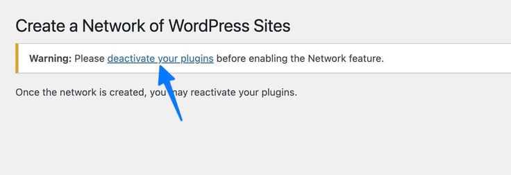 The WordPress "Create a Network of WordPress Sites" screen displays a warning message instructing the user to deactivate their plugins before enabling the Network feature, with a blue arrow pointing to the "deactivate your plugins" hyperlink, followed by a note that plugins may be reactivated once the network is created. The WordPress "Create a Network of WordPress Sites" screen displays a warning message instructing the user to deactivate their plugins before enabling the Network feature, with a blue arrow pointing to the "deactivate your plugins" hyperlink, followed by a note that plugins may be reactivated once the network is created.