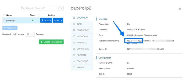 Image of the Kamatera server overview panel for a running cloud instance named paperclip2, displaying power state, guest OS, and zone information for a Singapore data center, arrow-annotated toward the highlighted public internet IP and hostname field used to access the server remotely. Image of the Kamatera server overview panel for a running cloud instance named paperclip2, displaying power state, guest OS, and zone information for a Singapore data center, arrow-annotated toward the highlighted public internet IP and hostname field used to access the server remotely.