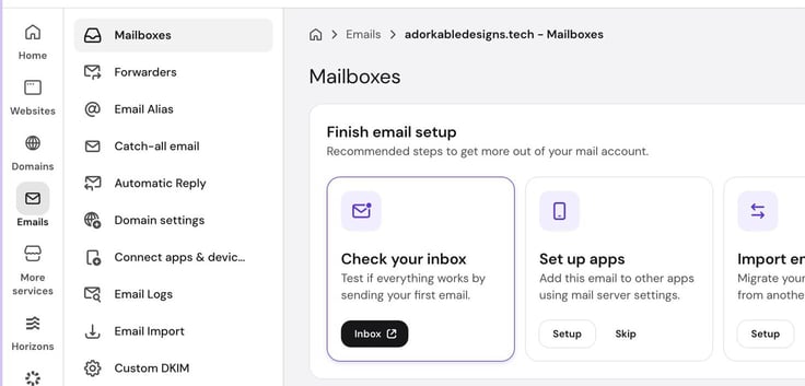 The Emails dashboard in Hostinger for the domain adorkabledesigns.tech, showing the Mailboxes section with a "Finish email setup" panel offering options to check the inbox, set up apps, or import existing email. The Emails dashboard in Hostinger for the domain adorkabledesigns.tech, showing the Mailboxes section with a "Finish email setup" panel offering options to check the inbox, set up apps, or import existing email.