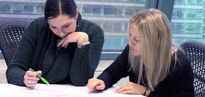SingleHop employees discuss paperwork