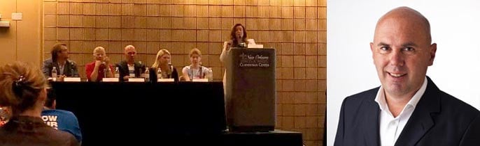 Photo of discussion panel at HostingCon with portrait of Wilfried Beeck