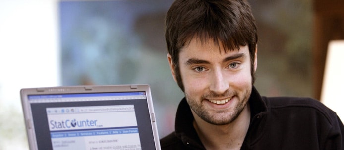 Aodhan Cullen Founder Aodhan Cullen with a laptop showing the StatCoutner logo