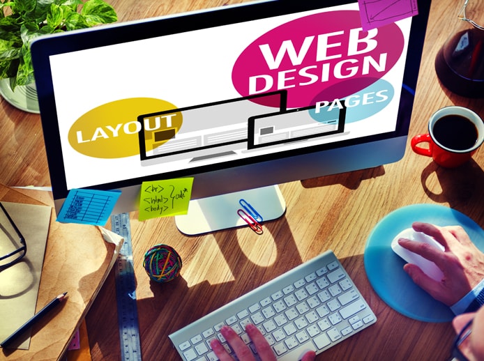 Depiction of someone at a desktop computer designing a website Depiction of someone at a desktop computer designing a website