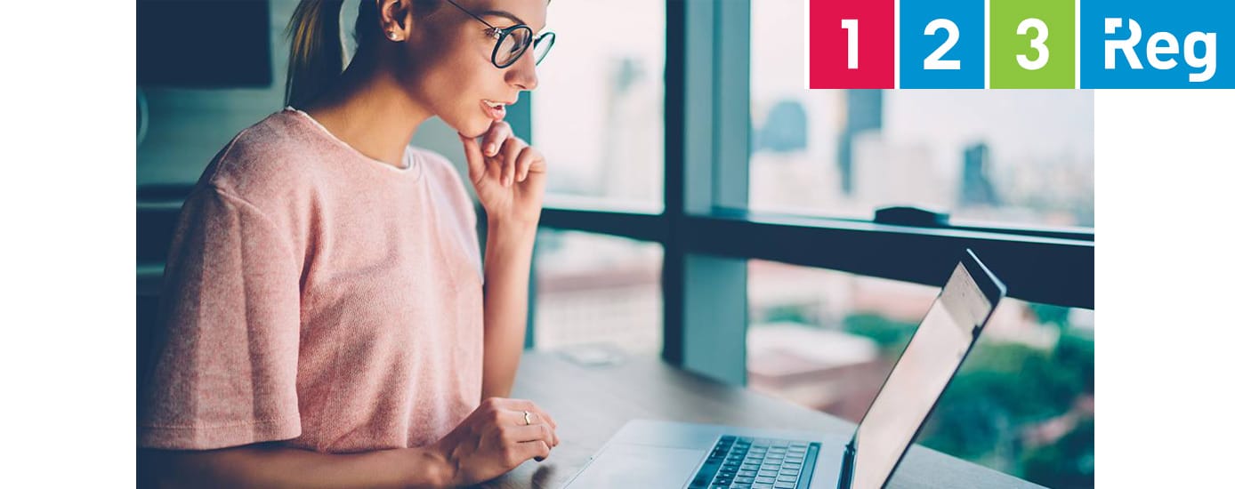 A young woman wearing black glasses building a website A young woman wearing black glasses building a website