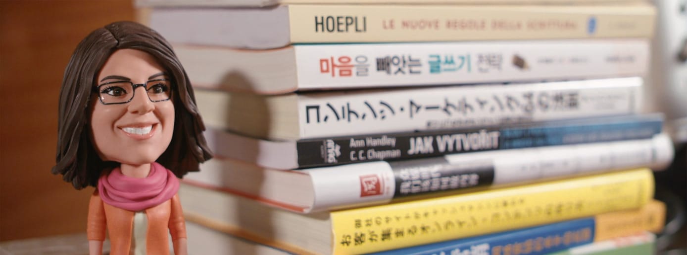 A photo of an Ann Handley bobblehead and her books in various languages A photo of an Ann Handley bobblehead and her books in various languages