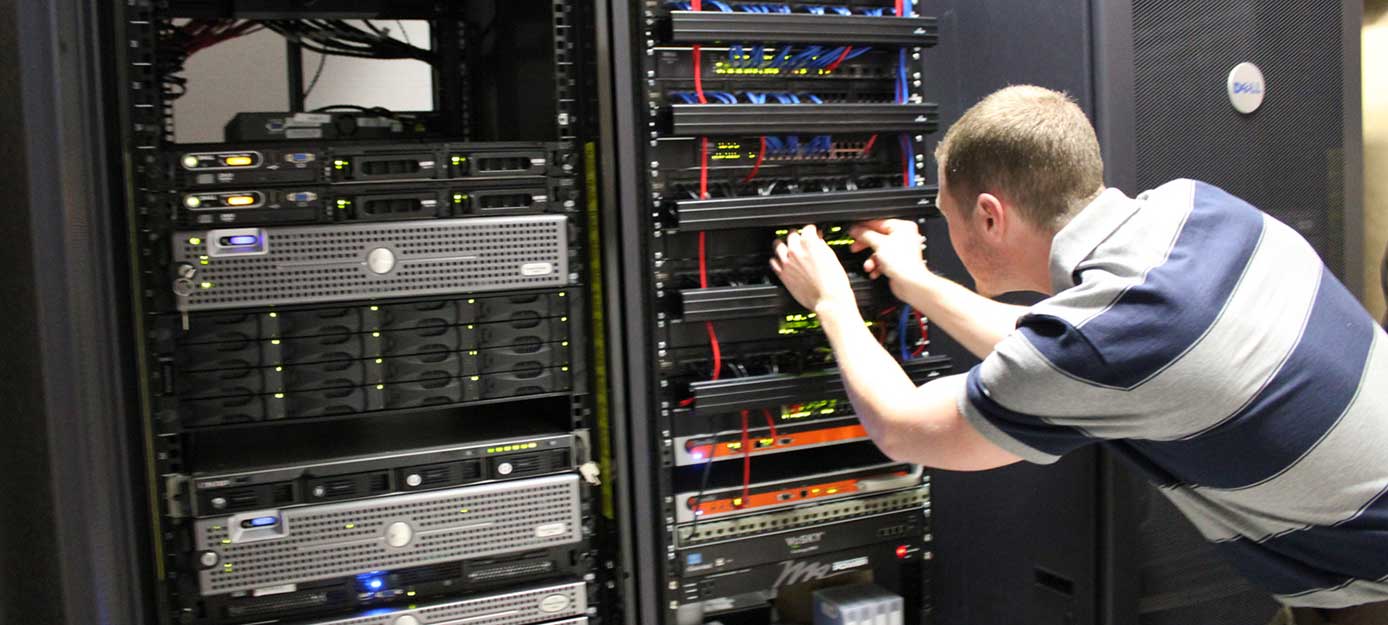 Image of a man working on a server Image of a man working on a server